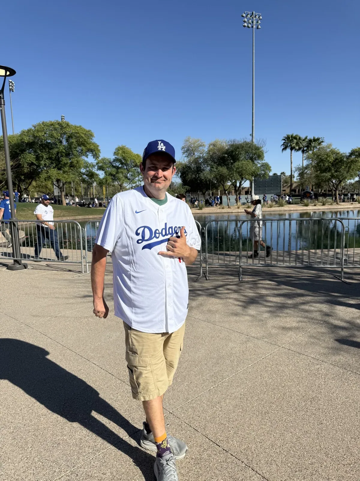 Kevin, after weight loss, in a Dodgers jersey and cap at the ballpark